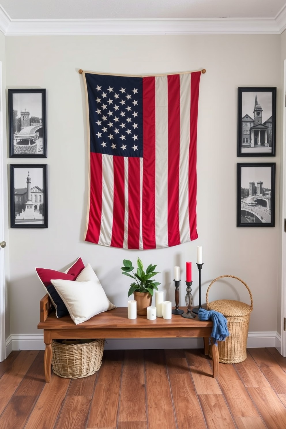 A charming entryway showcases a vintage American flag displayed prominently on the wall, evoking a sense of patriotism and nostalgia. The floor is adorned with a rustic wooden bench, and a woven basket filled with red, white, and blue decorative pillows sits nearby. Flanking the flag are framed black and white photographs of historical American landmarks, adding a touch of heritage to the space. A small console table beneath the flag is decorated with a potted plant and a collection of candles in festive colors, creating a warm and inviting atmosphere.