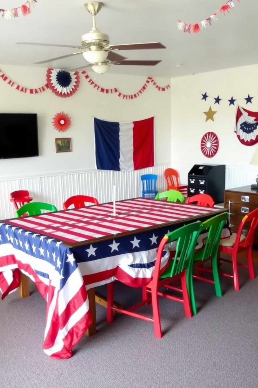 A vibrant game room decorated for Independence Day features a stars and stripes tablecloth draped over a large wooden table. Surrounding the table are colorful chairs, and the walls are adorned with festive red, white, and blue decorations, creating an inviting atmosphere for celebrations.