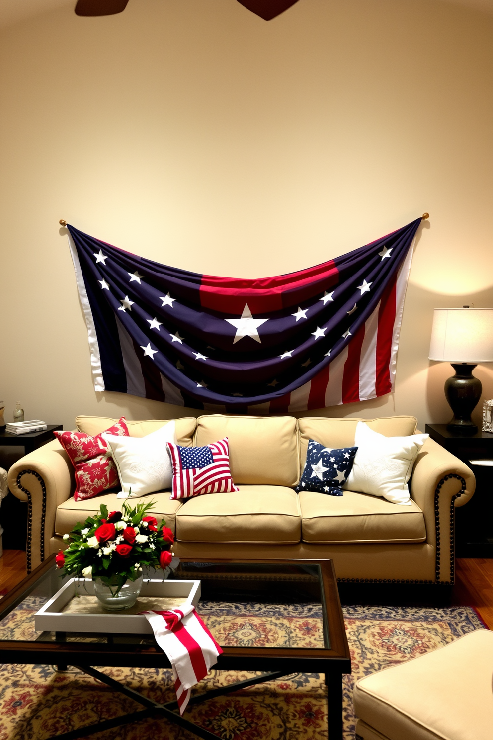 A cozy living room adorned for Independence Day features a star spangled banner elegantly draped over a plush beige sofa. The space is decorated with red white and blue throw pillows and a festive centerpiece on the coffee table.