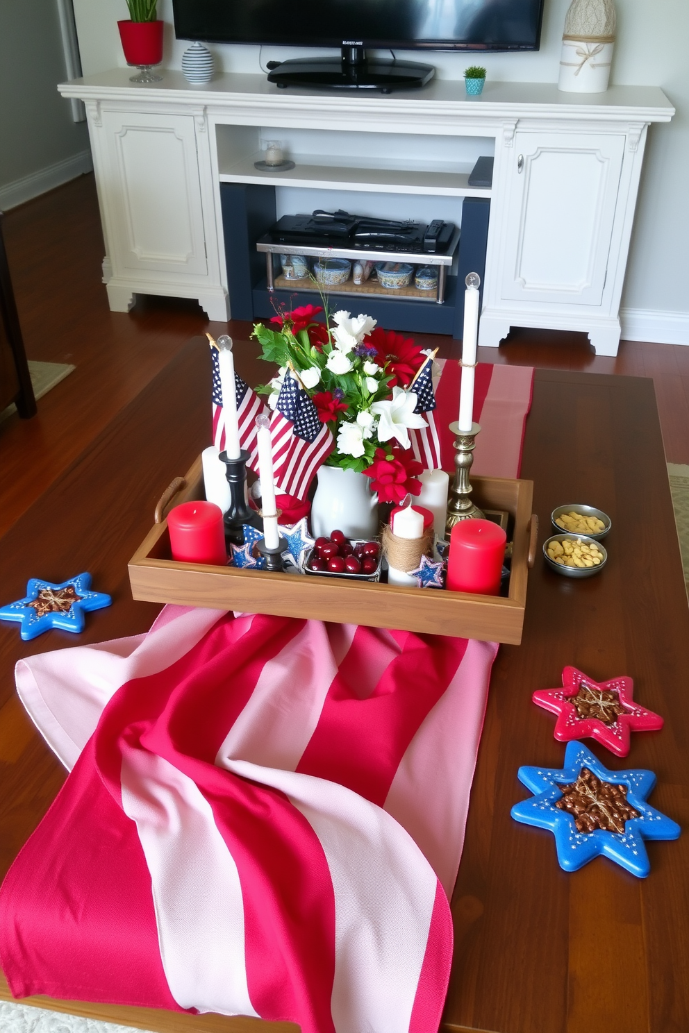 A patriotic themed coffee table centerpiece features a large red white and blue table runner that drapes elegantly across the surface. At the center, a rustic wooden tray holds an assortment of decorative items including small American flags and a bouquet of red white and blue flowers. Surrounding the tray are candles in varying heights wrapped in twine for a touch of rustic charm. The coffee table is adorned with star shaped coasters and a few festive snacks in vibrant colors to enhance the Independence Day spirit.