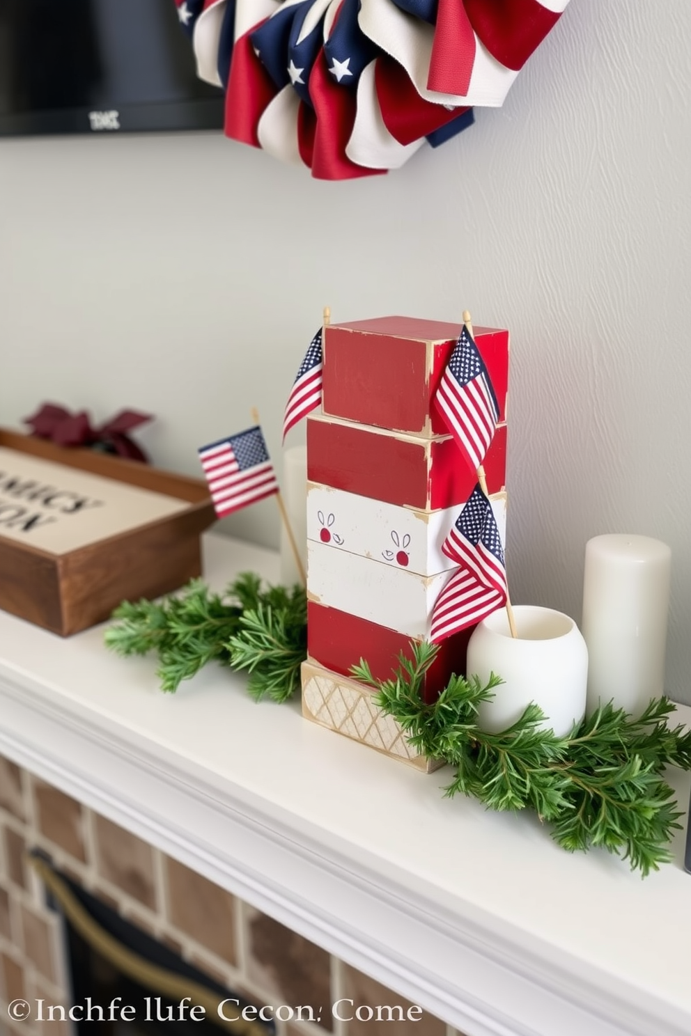 A festive mantel decorated for Independence Day features wooden blocks painted in red, white, and blue. The blocks are arranged in a playful stack, complemented by small American flags and seasonal greenery.