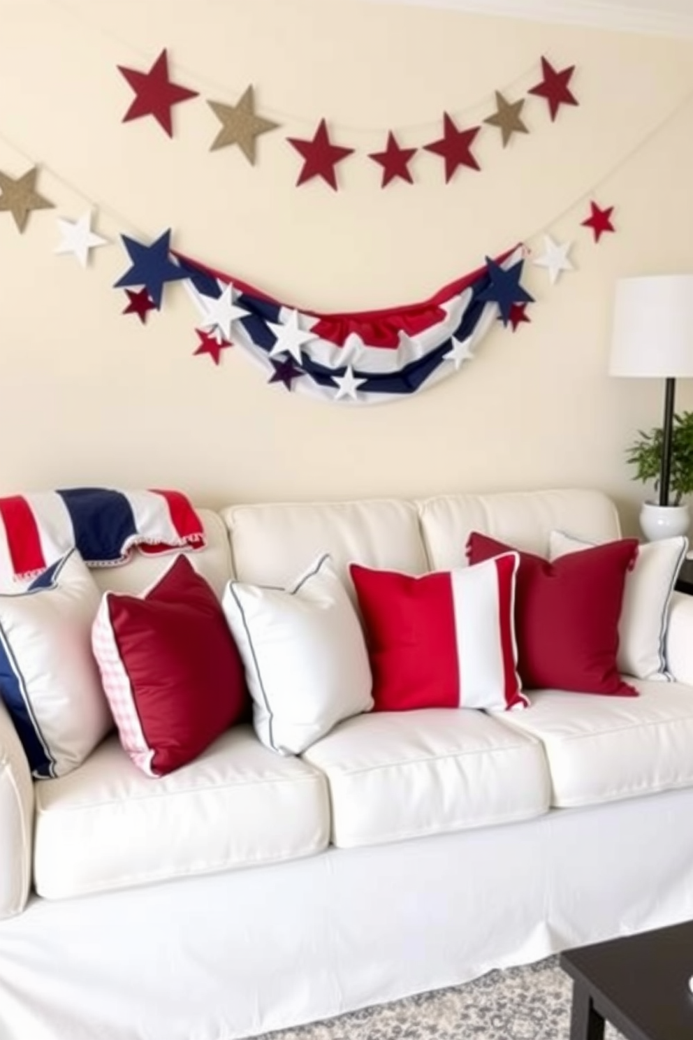 A cozy small living room decorated for Independence Day features a comfortable sofa adorned with red white and blue cushions. The walls are painted in a soft cream tone, and a festive garland of stars and stripes hangs above the sofa, enhancing the patriotic theme.