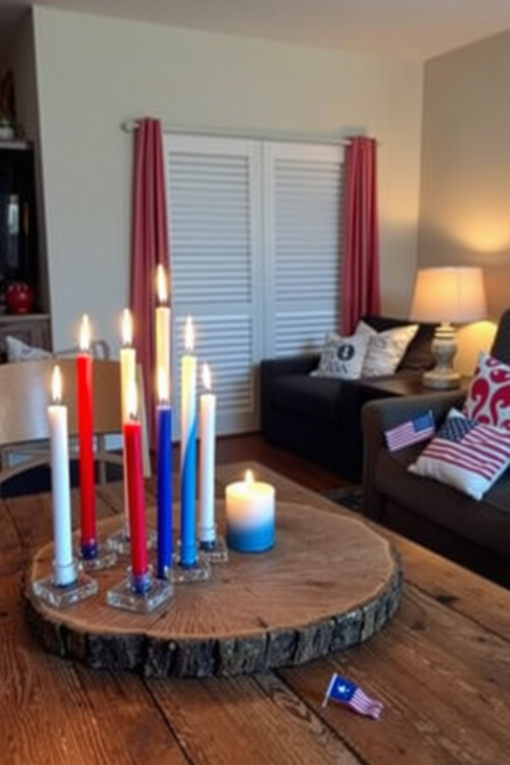 A collection of tricolor candles in red, white, and blue sits on a rustic wooden table, casting a warm and inviting glow throughout the room. The candles are arranged in varying heights, creating a visually appealing centerpiece that celebrates Independence Day. In a small living space, a clever arrangement of furniture maximizes comfort and functionality while maintaining a festive atmosphere. Decorative elements like patriotic throw pillows and small flags enhance the cozy vibe without overwhelming the limited space.