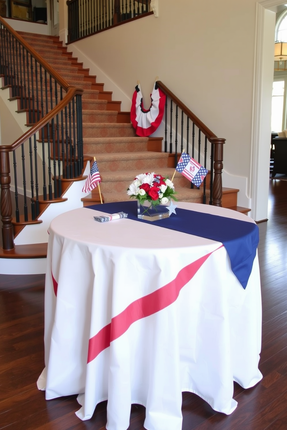 A patriotic themed tablecloth is draped elegantly over a wooden table at the landing of a grand staircase. Red white and blue accents are incorporated through decorative items like small flags and star shaped centerpieces.