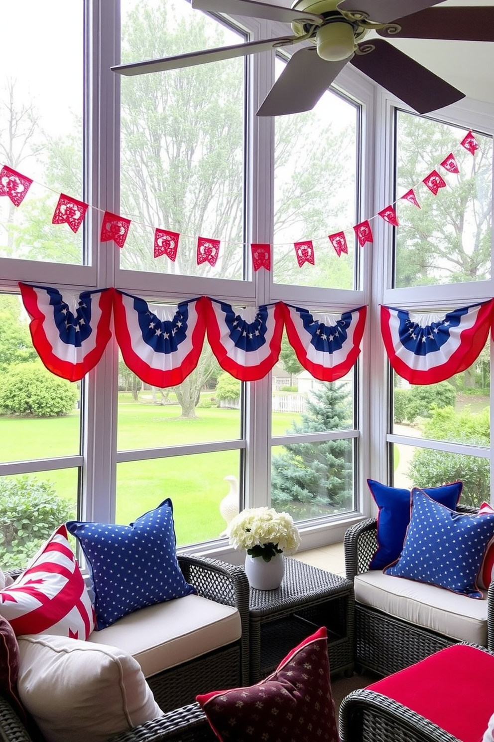 A sunroom decorated for Independence Day features colorful bunting draped across the windows creating a festive atmosphere. The space is filled with comfortable seating and vibrant cushions in red, white, and blue, inviting relaxation and celebration.