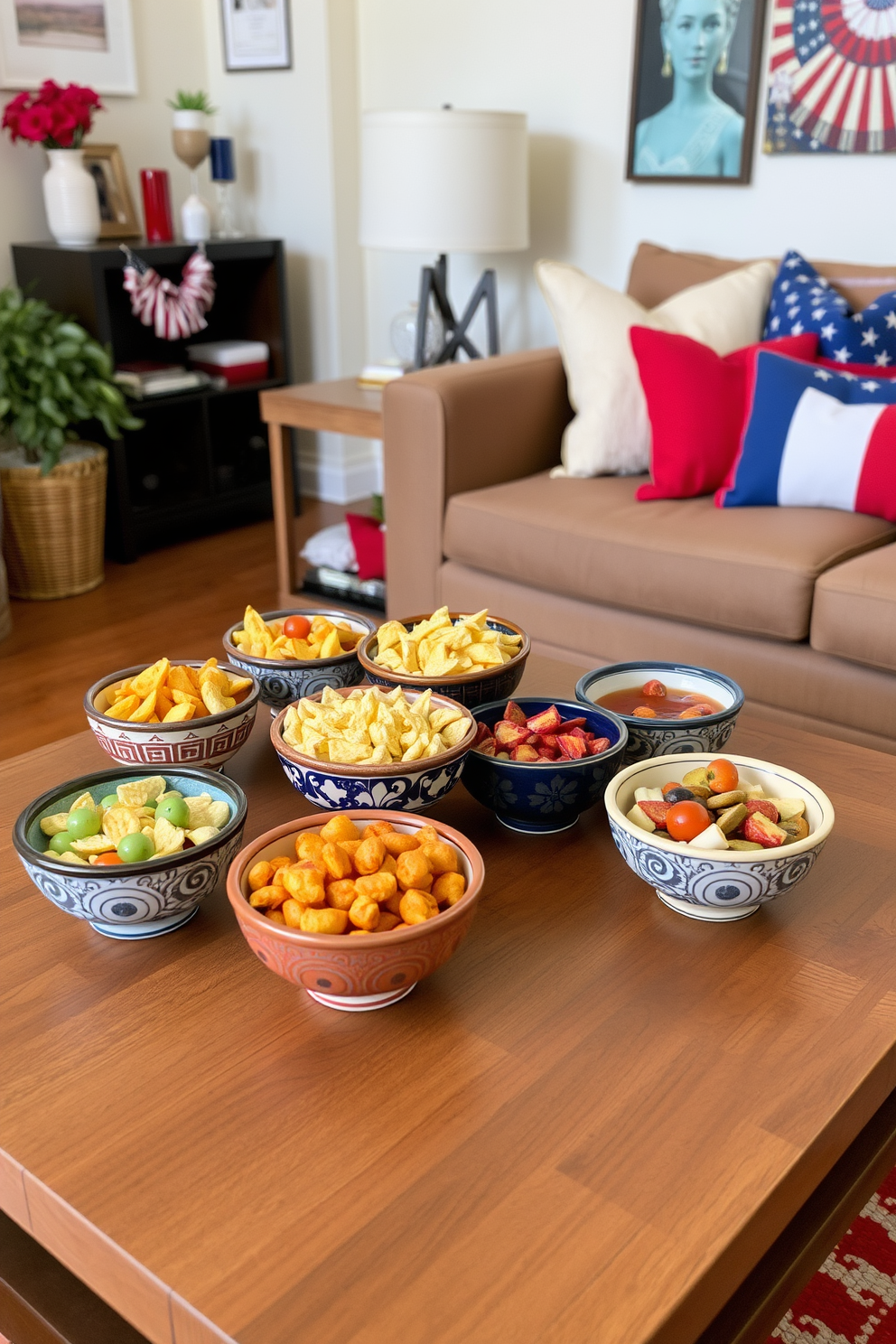 A vibrant display of decorative bowls filled with a variety of colorful snacks is arranged on a sleek wooden coffee table. The bowls are made of hand-painted ceramic, showcasing intricate designs that complement the cozy ambiance of the apartment. For Labor Day, the apartment is adorned with festive decorations, including red, white, and blue accents throughout the living space. Soft throw pillows and a patterned blanket on the couch create an inviting atmosphere for gathering with friends and family.