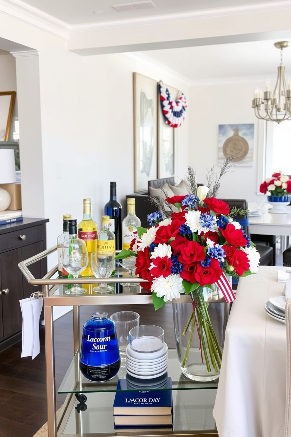 A stylish bar cart is elegantly set up in a modern dining room. It features a sleek metallic frame with glass shelves, displaying an array of premium spirits, mixers, and decorative glassware. For Labor Day, the dining room is adorned with festive decorations. A vibrant table centerpiece of red, white, and blue flowers complements the seasonal table settings and adds a cheerful touch to the space.