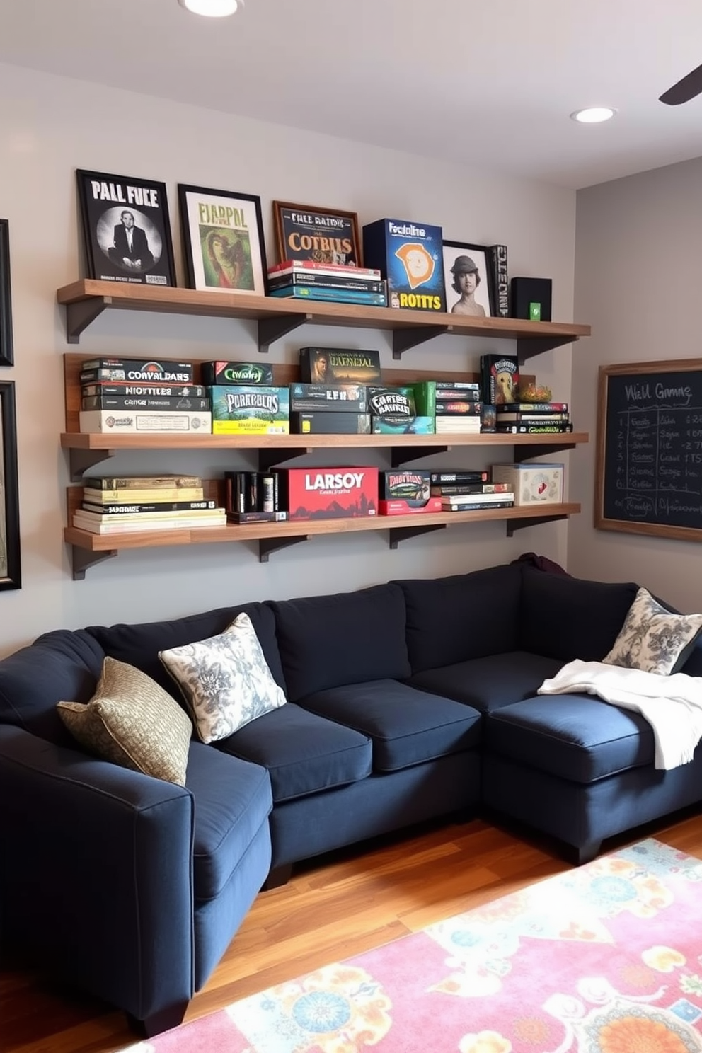 A stylish game room featuring wall-mounted game shelves that provide organized storage for board games and gaming accessories. The shelves are crafted from reclaimed wood and are painted in a soft gray, complementing the room's cozy atmosphere. The walls are adorned with framed game posters and a chalkboard for scorekeeping. A plush sectional sofa in a deep navy color invites relaxation, while a vibrant area rug adds a pop of color to the hardwood floor.