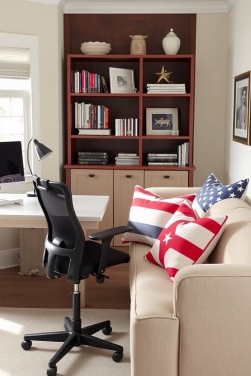 A cozy home office setting features a sleek desk paired with a comfortable ergonomic chair. The space is adorned with red, white, and blue throw pillows arranged on a plush sofa, adding a festive touch for Labor Day. The walls are painted in a soft neutral tone, creating a calm backdrop for productivity. A stylish bookshelf filled with books and decorative items complements the patriotic color scheme, enhancing the overall decor.