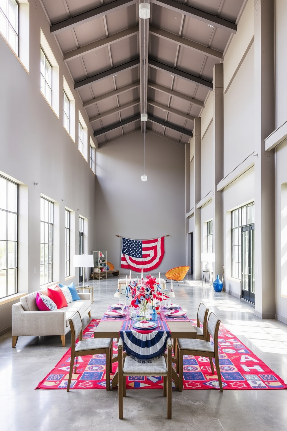 A modern loft space with open ceilings and large windows allowing natural light to flood in. The walls are painted in a soft gray, and the floor features polished concrete. Add a pop of color with vibrant accessories such as throw pillows in bright hues and a colorful area rug. Incorporate Labor Day themed decorations like a festive table setting with red, white, and blue accents.