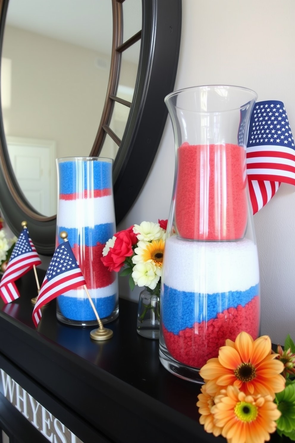 A stylish mantel decorated for Labor Day features glass vases filled with layers of colored sand in red white and blue. The vases are arranged alongside small American flags and seasonal flowers creating a festive and inviting atmosphere.