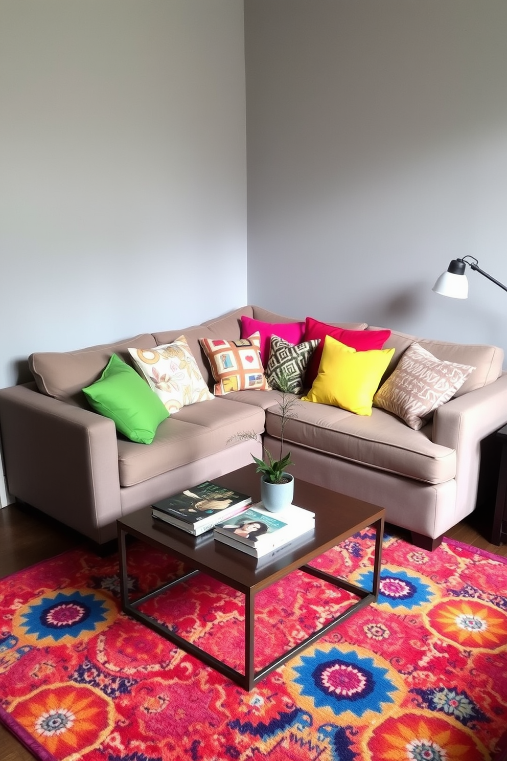 Bright cushions adding a pop of color are scattered across a cozy sectional sofa in a small living room. The walls are painted in a soft gray, and a vibrant area rug ties the space together, creating an inviting atmosphere for relaxation and conversation. Decorative throw pillows in various patterns complement the cushions, enhancing the room's eclectic style. A small coffee table adorned with a few art books and a potted plant sits at the center, inviting guests to gather and enjoy the space.