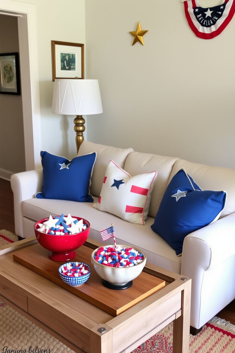 A cozy living room setting designed for Labor Day celebrations. Decorative bowls filled with red white and blue treats are arranged on a coffee table, creating a festive atmosphere. The walls are adorned with subtle patriotic artwork, enhancing the small space's charm. Soft throw pillows in coordinating colors are placed on a compact sofa, inviting guests to relax and enjoy the festivities.