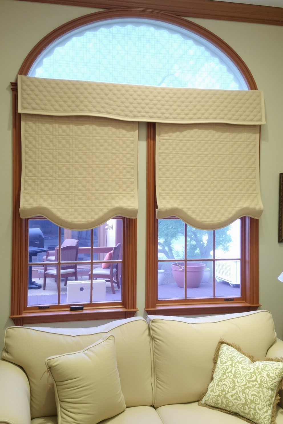 A cozy living room adorned with quilted fabric hanging as window treatments. The fabric features a subtle pattern that complements the soft color palette of the room. The windows are framed with elegant wooden trim, enhancing the overall warmth of the space. A plush sofa and decorative cushions in coordinating colors complete the inviting atmosphere.