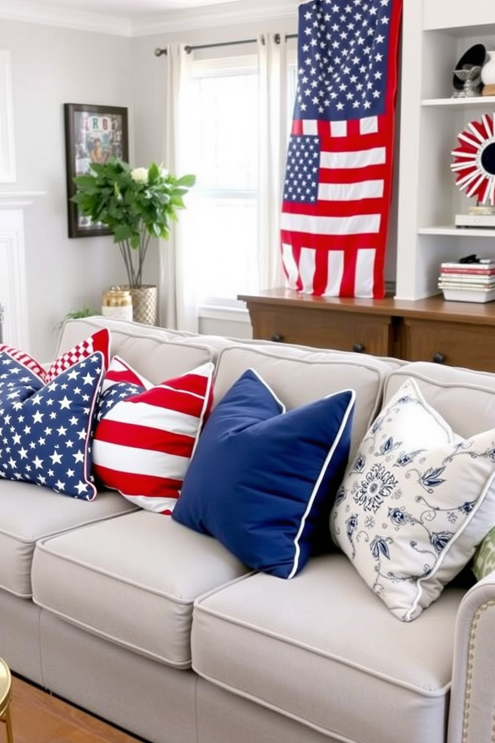 A cozy living room adorned with red white and blue throw pillows that celebrate Memorial Day. The pillows are arranged on a light gray sofa, complementing the patriotic theme with various patterns and textures.