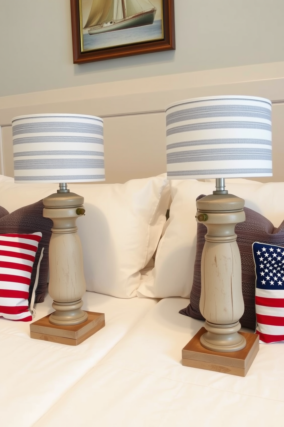 A pair of nautical themed bedside lamps sit on either side of a cozy bed. The lamps feature weathered wooden bases and blue and white striped shades, evoking a serene coastal vibe. The bedroom is adorned with red, white, and blue accents to celebrate Memorial Day. Soft throw pillows in patriotic colors complement the bedding, creating a warm and inviting atmosphere.