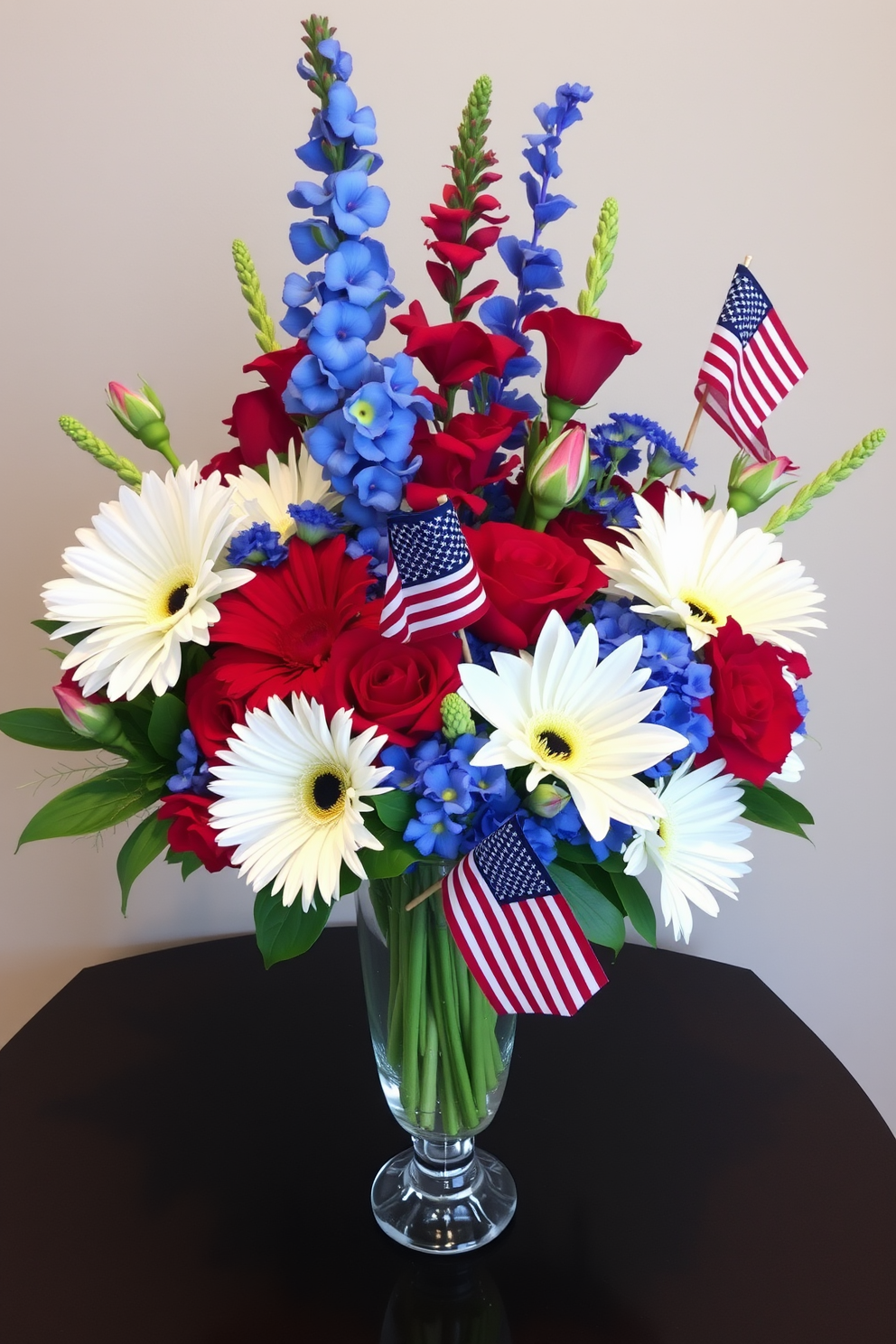 Festive floral arrangements featuring vibrant red white and blue blooms are artfully displayed in elegant vases. Small flags are interspersed throughout the arrangement adding a patriotic touch perfect for Memorial Day celebrations.