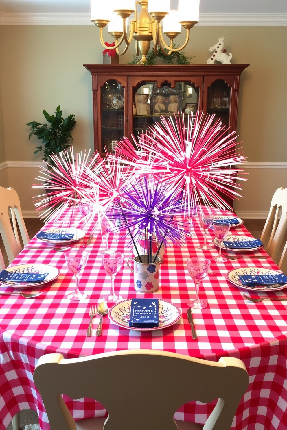 A vibrant dining room setting adorned with tabletop fireworks decorations for a festive Memorial Day celebration. The table is set with a red and white checkered tablecloth, and colorful fireworks centerpieces are placed in the middle, surrounded by plates and glasses that reflect the patriotic theme.