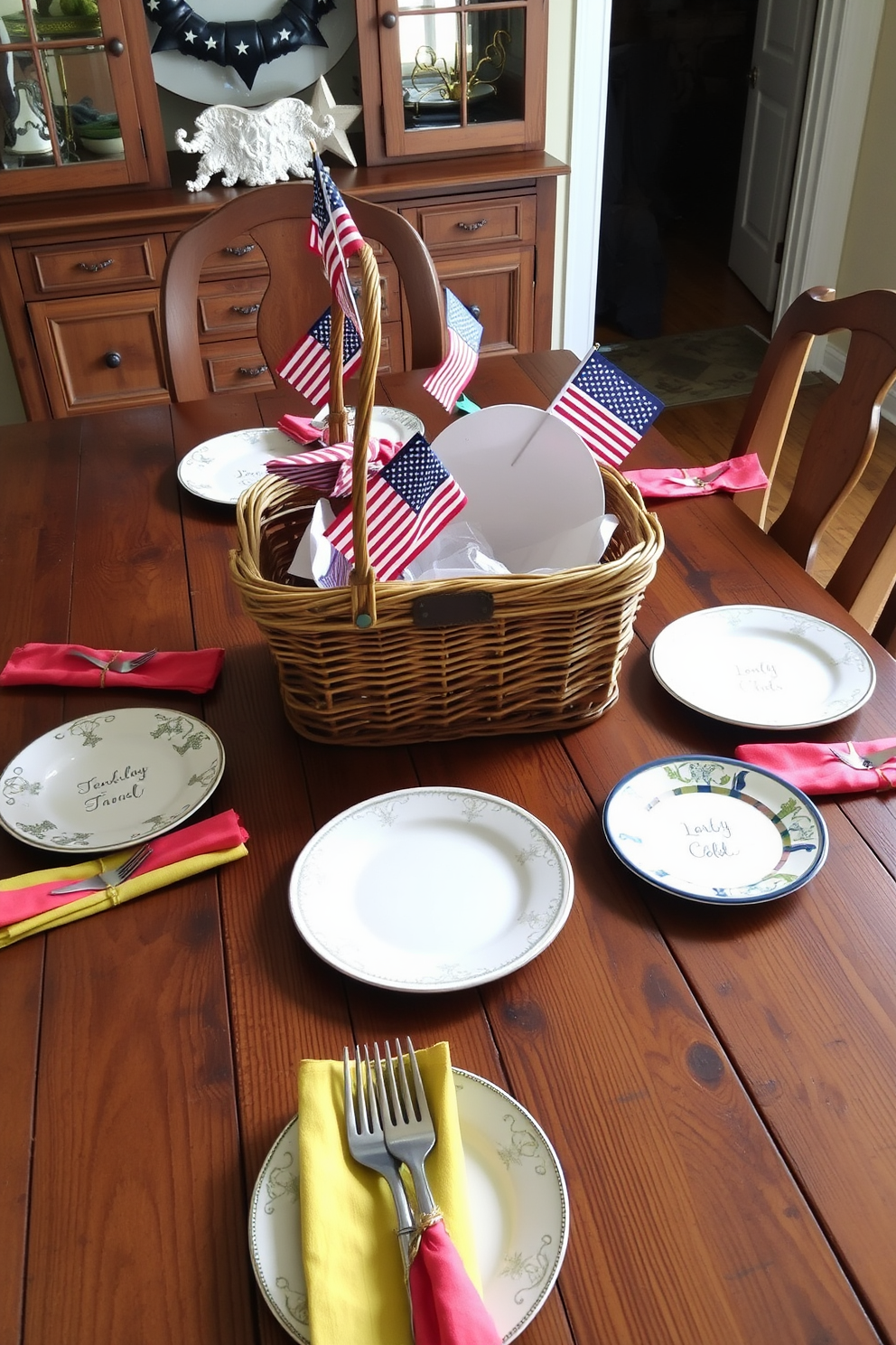 A vintage picnic basket serves as a charming centerpiece on a rustic wooden dining table. Surrounding the basket, a collection of mismatched plates and colorful napkins adds a festive touch to the Memorial Day celebration.