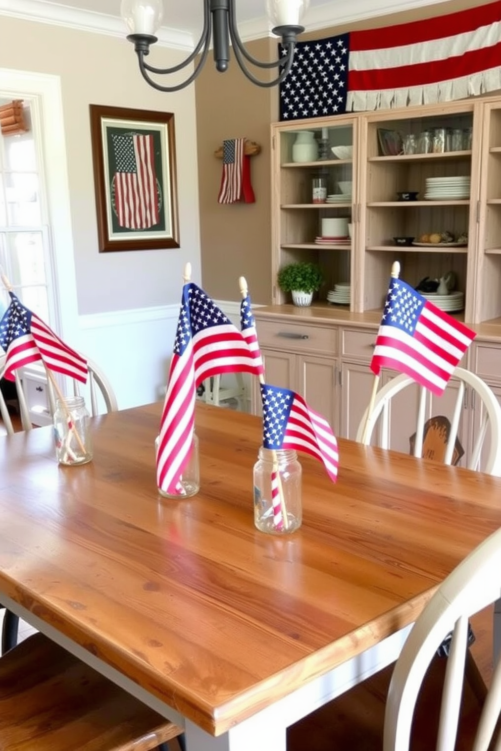 A charming dining room featuring a rustic wooden table adorned with vintage American flags placed in mason jars. The table is surrounded by mismatched chairs, and the walls are decorated with patriotic-themed artwork, creating a warm and inviting atmosphere for Memorial Day celebrations.