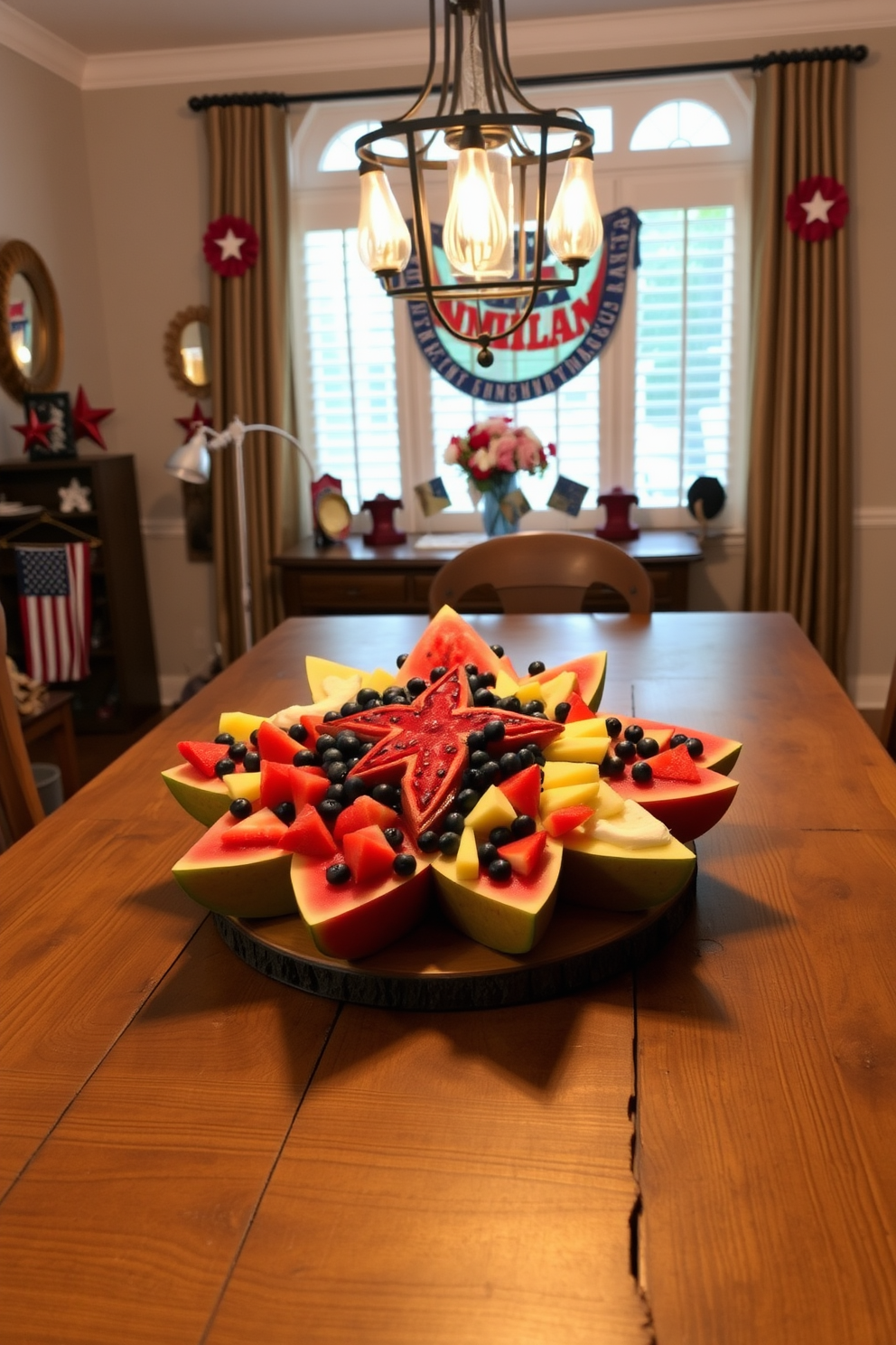 A beautifully arranged star shaped fruit platter is displayed on a rustic wooden dining table. The platter features an assortment of vibrant fruits including watermelon, pineapple, and blueberries, artfully arranged to create a festive atmosphere for guests. The dining room is adorned with red, white, and blue decorations to celebrate Memorial Day. Soft lighting from elegant pendant fixtures casts a warm glow over the table, enhancing the inviting ambiance for family and friends.