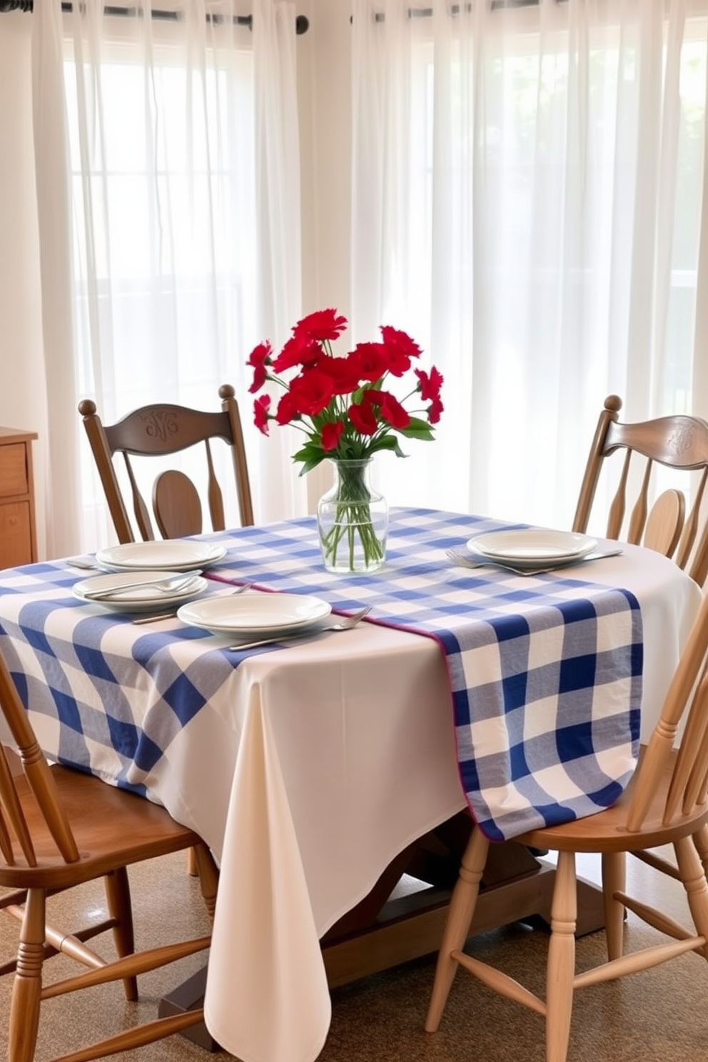 A charming dining room setting featuring a blue and white checkered tablecloth draped elegantly over a rustic wooden table. The table is set with white dinnerware, silver utensils, and vibrant red flowers in a glass vase as a centerpiece. Around the table, mismatched wooden chairs create a cozy and inviting atmosphere. Soft, natural light filters through sheer curtains, enhancing the festive ambiance of the Memorial Day celebration.