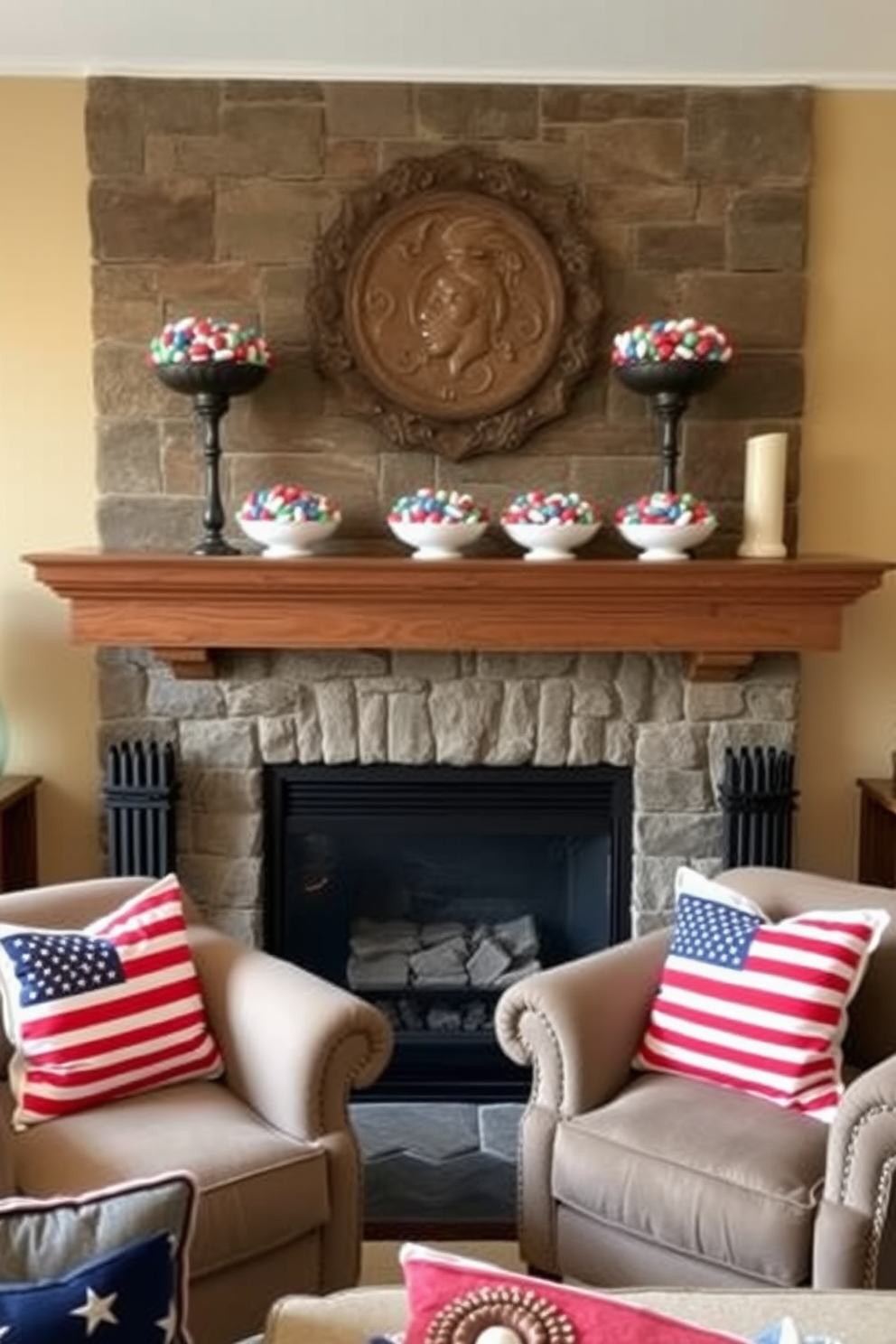 A cozy living room setting with a rustic fireplace as the focal point. The mantel is adorned with decorative bowls filled with colorful flag candies, celebrating Memorial Day. The walls are painted in a warm beige tone, creating an inviting atmosphere. Plush seating arrangements are positioned around the fireplace, with patriotic-themed throw pillows adding a festive touch.