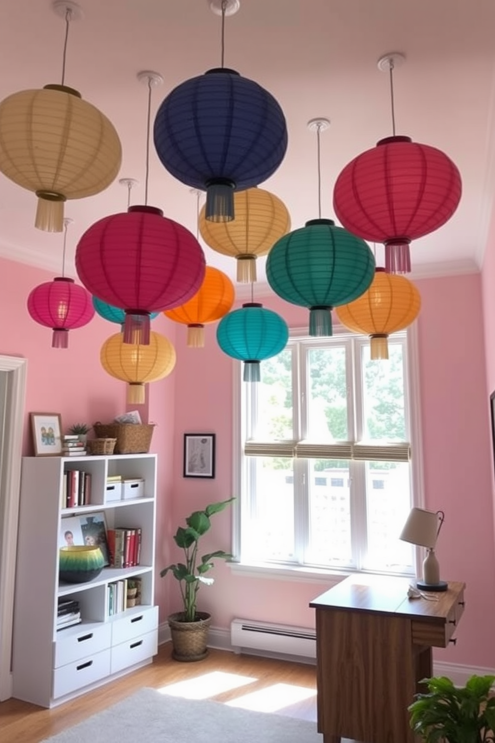 A cozy home office adorned with colorful paper lanterns hanging overhead creates a vibrant atmosphere. The walls are painted in soft pastels, and a sleek wooden desk is positioned near a large window, allowing natural light to flood the space.