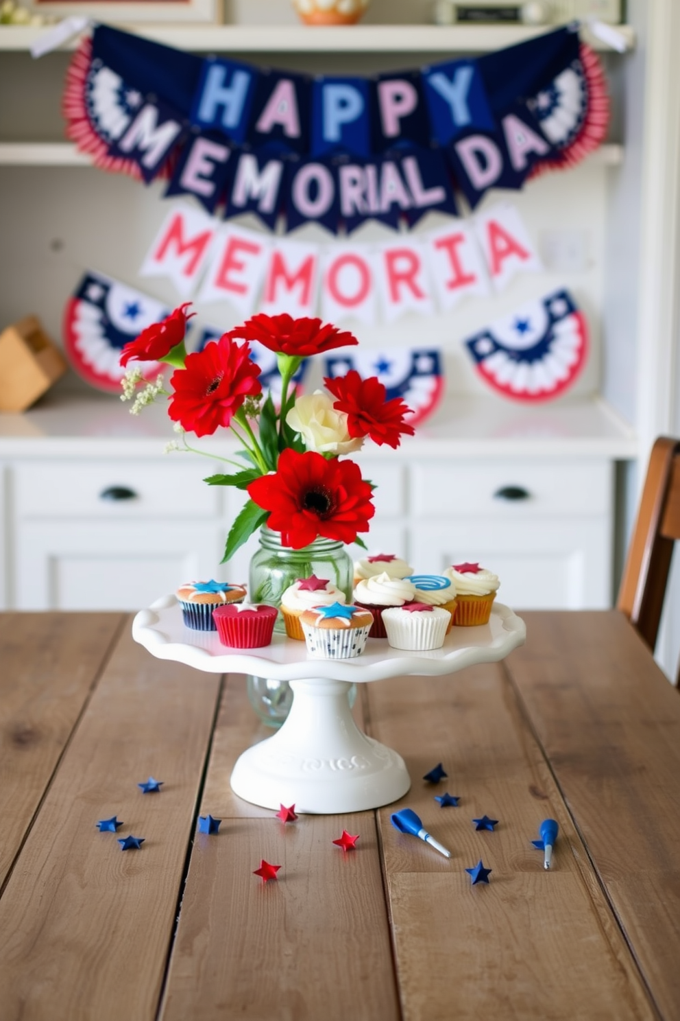 A patriotic themed cake stand is elegantly displayed on a rustic wooden table adorned with red white and blue decorations. The stand showcases an array of delicious desserts including cupcakes and cookies decorated with stars and stripes. In the background, a festive banner reading Happy Memorial Day hangs above the table, complementing the overall theme. Fresh flowers in red and white hues are arranged in a mason jar, adding a touch of charm to the kitchen decor.