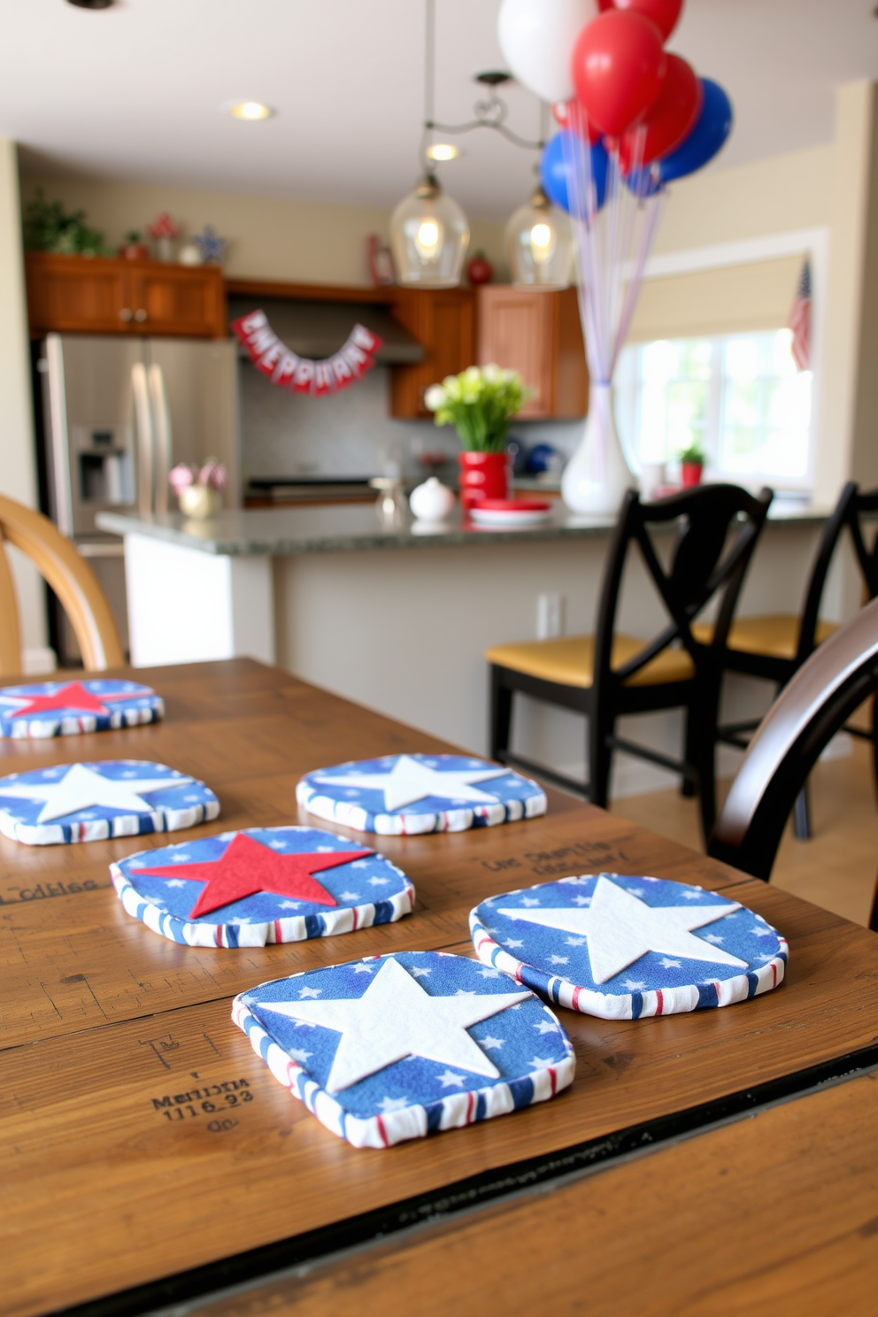 Festive coasters featuring star patterns adorn a rustic wooden dining table. The coasters are crafted from vibrant fabric, adding a pop of color to the space while celebrating the spirit of Memorial Day. In the background, a beautifully arranged kitchen showcases red, white, and blue decor elements. Banners and balloons in patriotic colors hang above the countertops, creating a cheerful and inviting atmosphere.