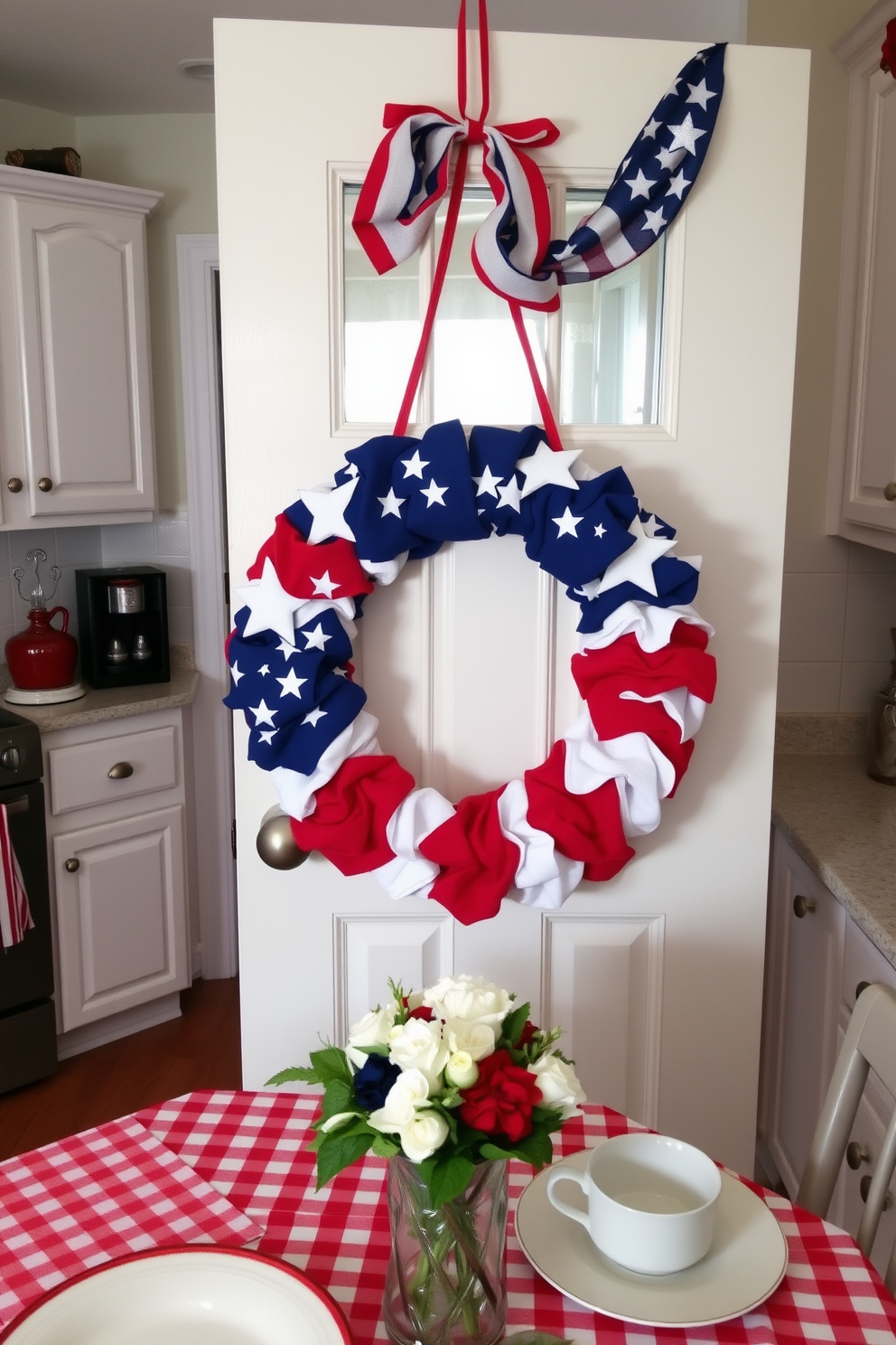 A charming kitchen adorned for Memorial Day features a DIY wreath made of red, white, and blue fabric with stars and stripes. The wreath hangs prominently on the door, complemented by a festive table setting that includes a checkered tablecloth and themed dishware.