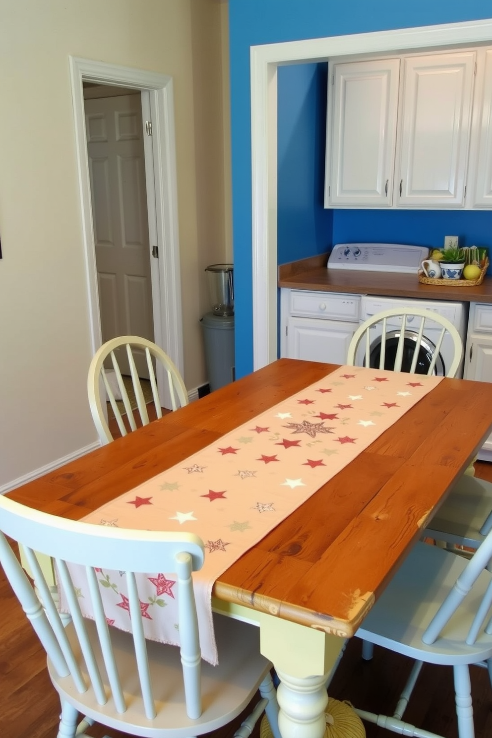 A seasonal table runner adorned with stars stretches elegantly across a rustic wooden dining table. Surrounding the table are mismatched chairs in soft pastel hues, creating a cheerful and inviting atmosphere. In the laundry room, bright white cabinets contrast with a vibrant blue accent wall. A decorative shelf displays neatly folded towels and a potted plant, adding a touch of warmth and personality to the space.