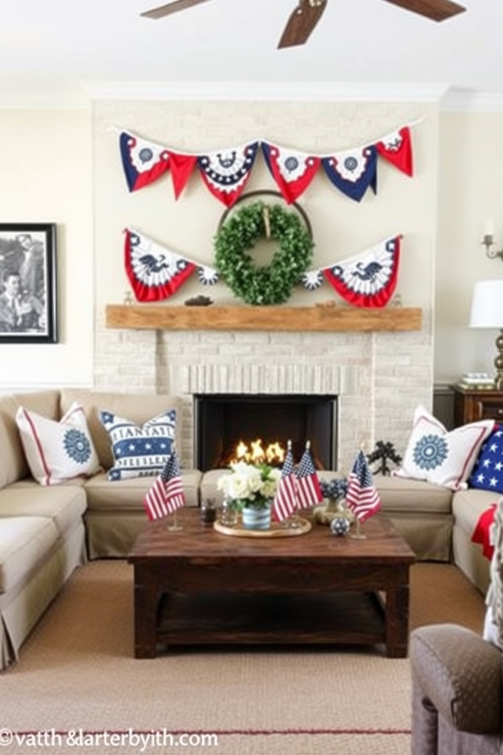 A cozy living room setting for Memorial Day. Bunting flags in red white and blue are draped across the mantel above a warm fireplace. The room features a comfortable sectional sofa adorned with patriotic cushions. A rustic coffee table sits in front of the sofa surrounded by small American flags and seasonal decor.