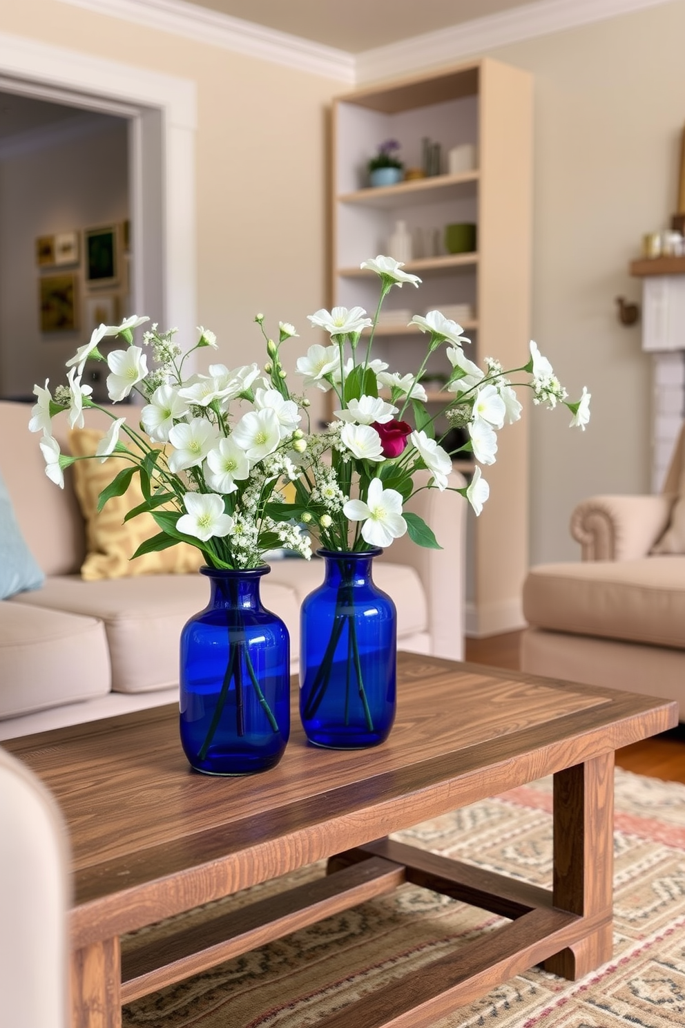 A serene living room setting featuring blue vases filled with fresh white flowers. The vases are strategically placed on a rustic wooden coffee table, enhancing the room's inviting atmosphere.