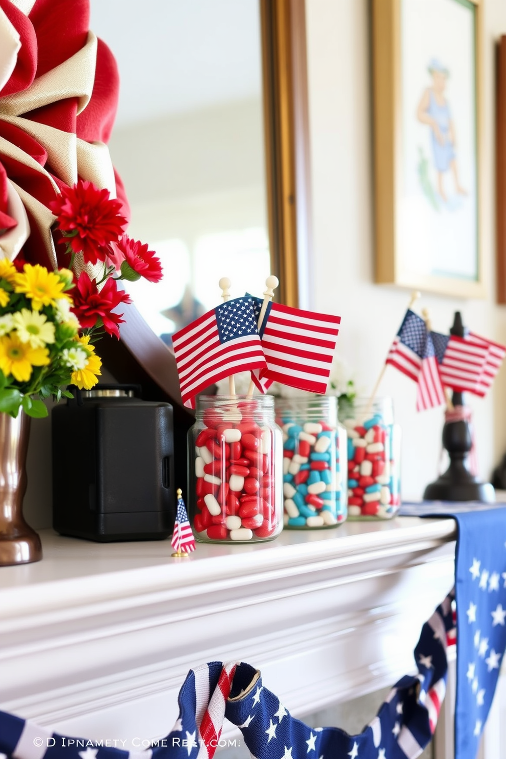 A festive mantel decorated for Memorial Day. Glass jars filled with red, white, and blue candies are arranged alongside small American flags and seasonal flowers.