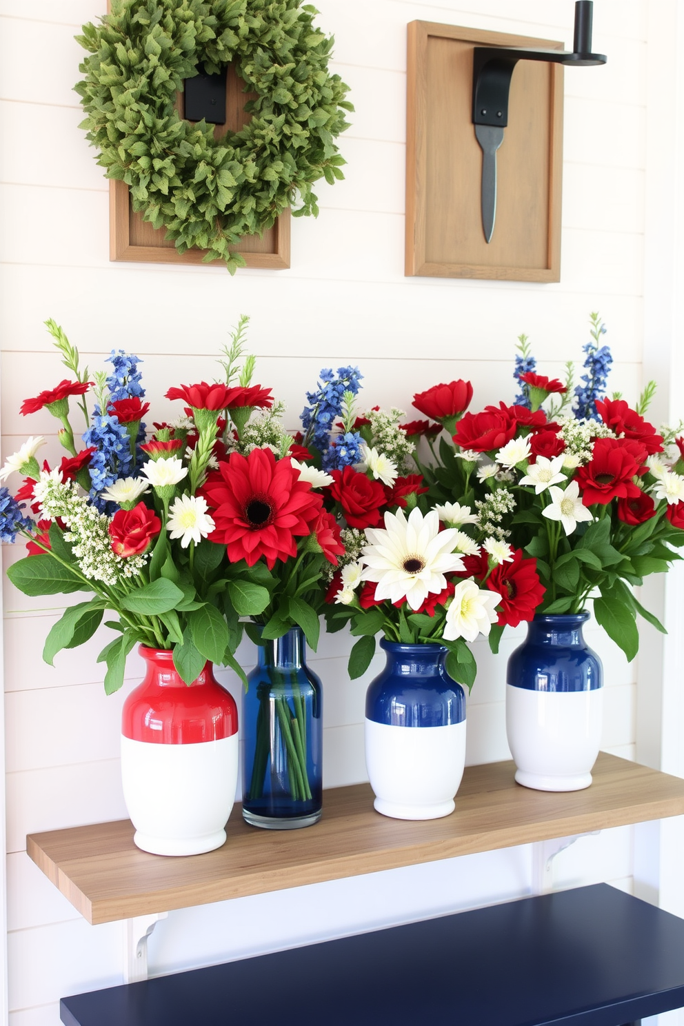 Fresh flowers in red white and blue vases create a vibrant and festive atmosphere in the mudroom. The vases are arranged on a rustic wooden shelf, complemented by a backdrop of white shiplap walls and a navy blue bench.