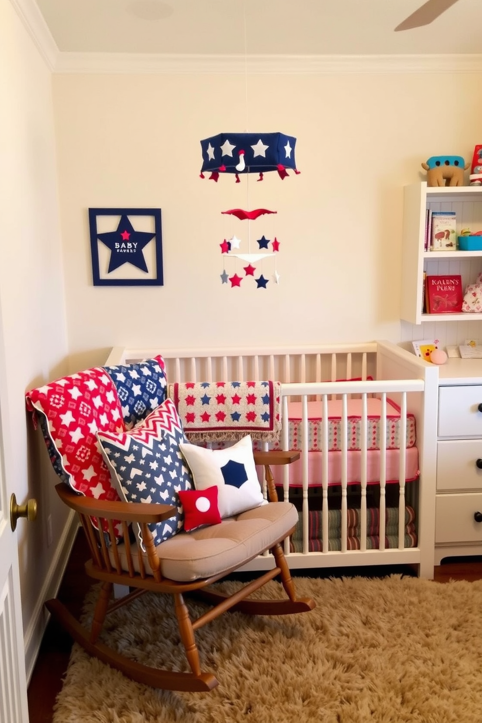 Cushions with red white and blue patterns are arranged on a cozy rocking chair in a nursery. The walls are painted in a soft pastel shade, and a plush area rug adds warmth to the space. A whimsical mobile hangs above the crib, complementing the patriotic theme. Shelves adorned with children's books and toys complete the inviting atmosphere.