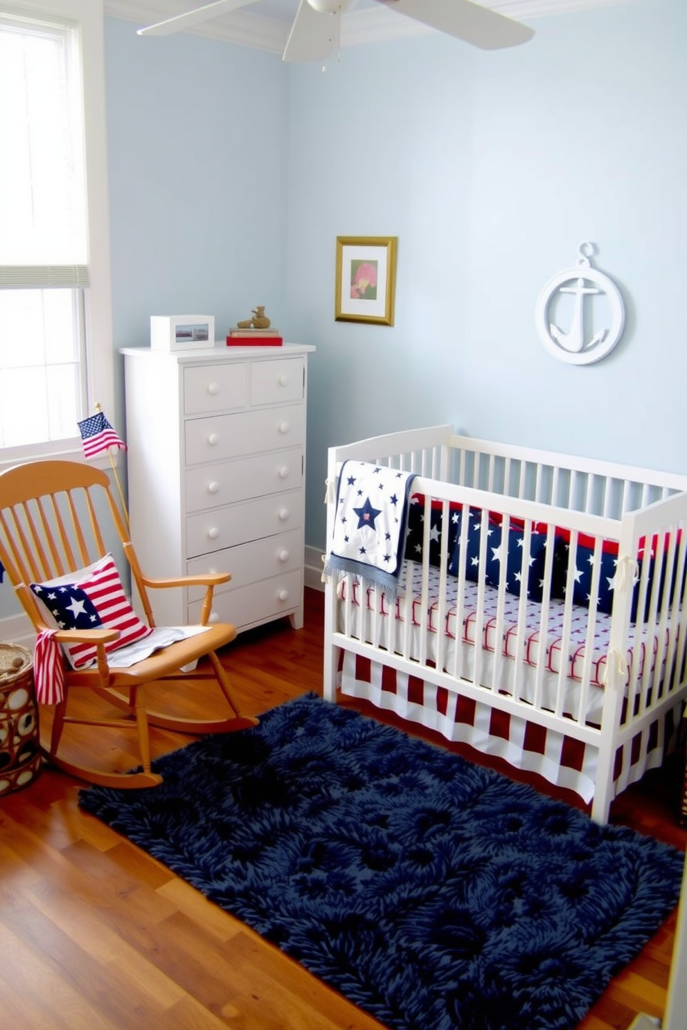 A charming nursery featuring a stars and stripes crib bedding set. The walls are painted in a soft pastel blue, and a wooden rocking chair is placed in the corner. A white dresser with nautical-themed decor sits against one wall. A plush area rug adds warmth to the space, creating a cozy atmosphere for Memorial Day celebrations.