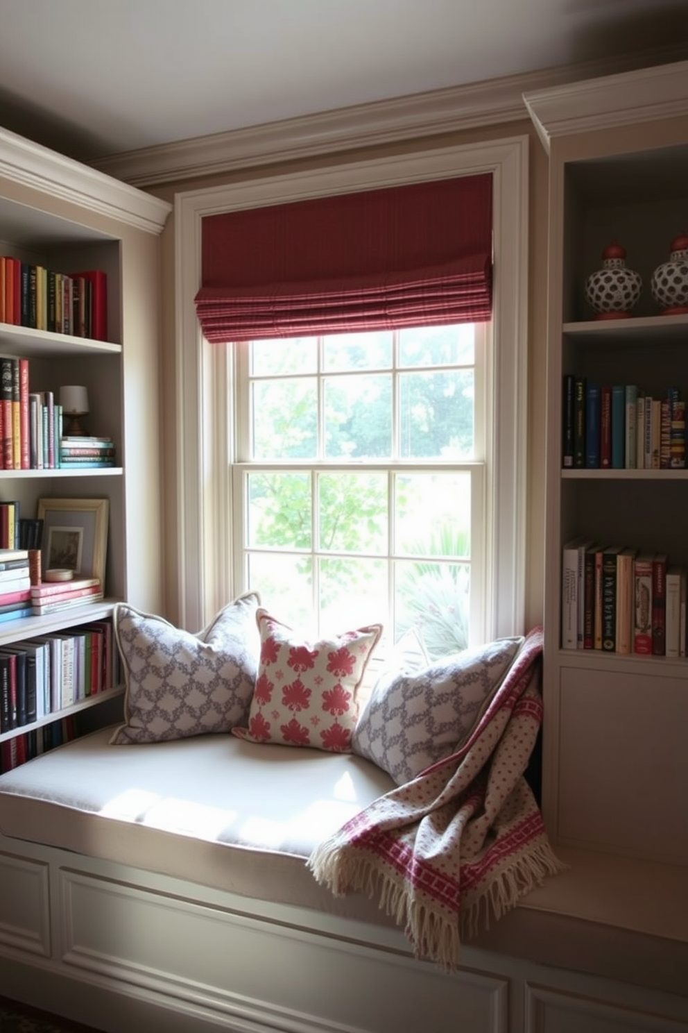 A cozy window seat adorned with plush cushions invites relaxation and tranquility. Surrounding the seat, bookshelves filled with colorful novels and decorative items create a charming reading nook perfect for Memorial Day. Natural light pours in through the large window, illuminating the space with warmth. Soft, patterned throw blankets drape over the cushions, adding a touch of comfort and style.