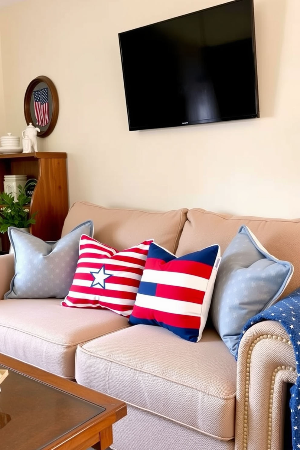 Cozy small living room adorned with red white and blue throw pillows that evoke a festive Memorial Day spirit. The pillows are arranged on a neutral-toned sofa, complementing the warm ambiance of the room.