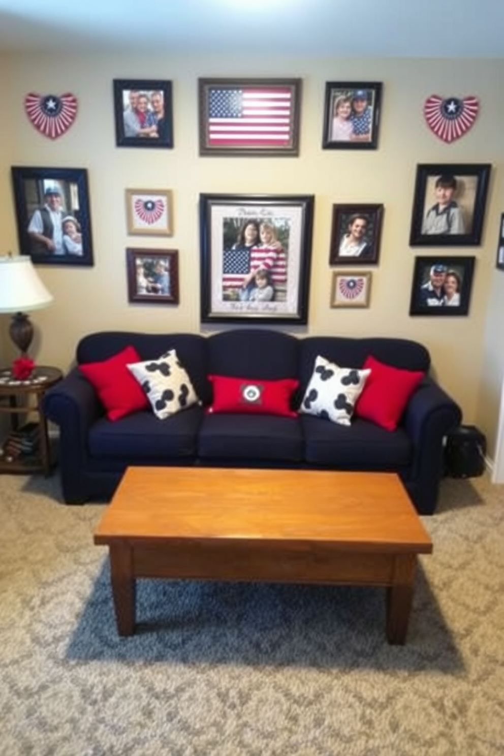 A cozy small living room adorned with framed family photos in patriotic frames celebrating Memorial Day. The walls are painted a soft beige, and a comfortable navy blue sofa sits in the center, accented by red and white throw pillows.