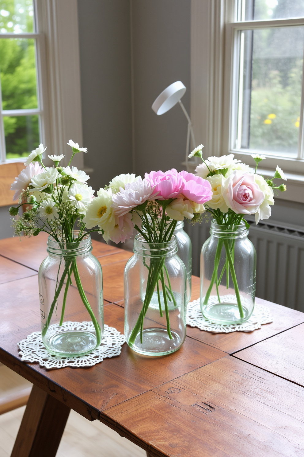 Vintage jars filled with fresh blooms sit on a rustic wooden table. The soft pastel colors of the flowers contrast beautifully with the aged glass of the jars, creating a charming and inviting atmosphere. Delicate lace doilies are placed underneath each jar, adding an elegant touch to the display. Natural light filters through a nearby window, enhancing the vibrant colors and creating a warm, welcoming space.