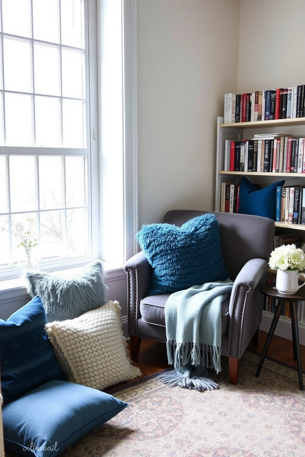 Create a cozy reading nook with plush cushions in various shades of blue and soft textures. A large window lets in natural light, and a small bookshelf filled with books lines the wall beside a comfortable armchair. Add a soft throw blanket draped over the armchair for warmth and a small side table to hold a steaming cup of tea. A patterned rug underfoot anchors the space, creating an inviting atmosphere perfect for relaxation.