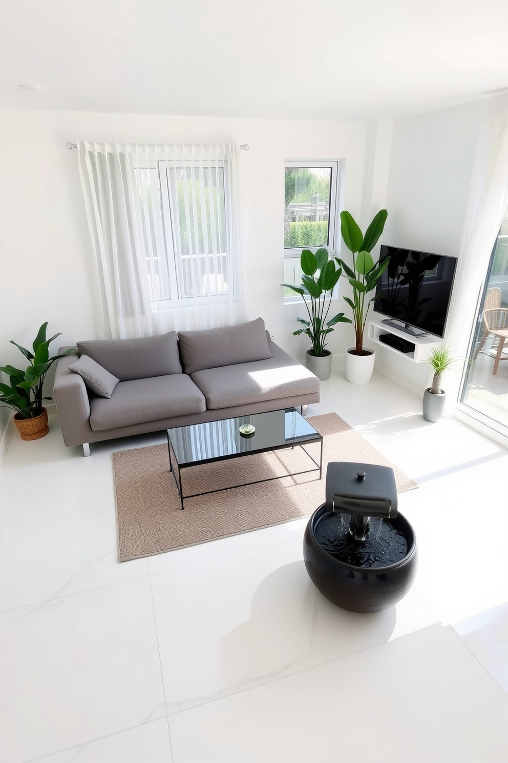 A cozy living room with a minimalist design. There's a comfortable gray sofa facing a sleek coffee table, and a small indoor fountain is placed in the corner for tranquility. The walls are painted in soft white, and natural light floods in through large windows adorned with sheer curtains. A few potted plants are strategically placed around the room, adding a touch of greenery to the space.