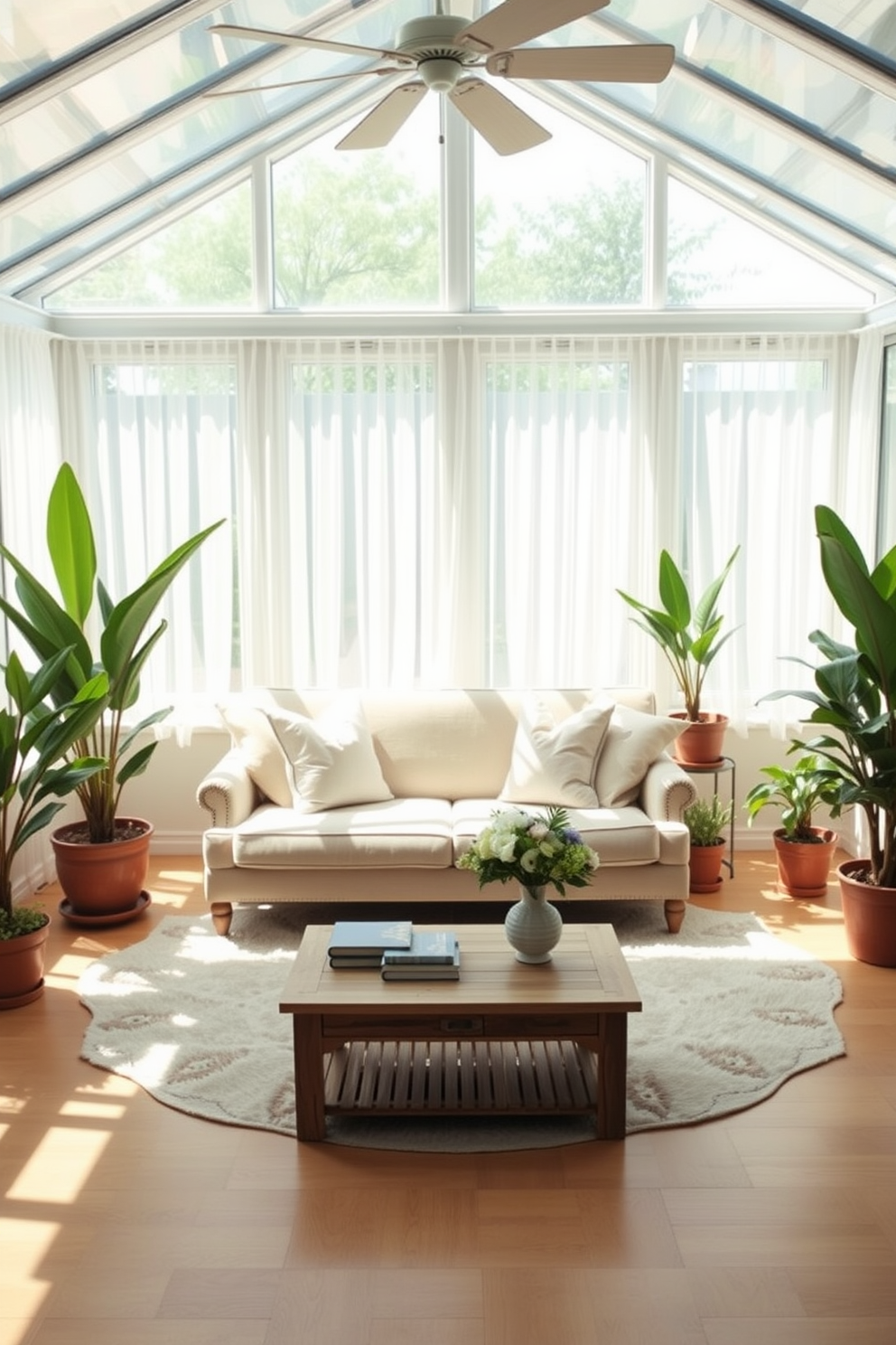 A bright and airy sunroom filled with natural light. There are large windows adorned with sheer white curtains that gently diffuse the sunlight. In the center, a comfortable seating arrangement features a plush sofa with pastel-colored cushions. A cozy area rug adds warmth underfoot, complementing the natural wood flooring. Potted plants are strategically placed around the room, bringing a touch of greenery indoors. A small wooden coffee table sits in front of the sofa, topped with a few decorative books and a vase of fresh flowers.