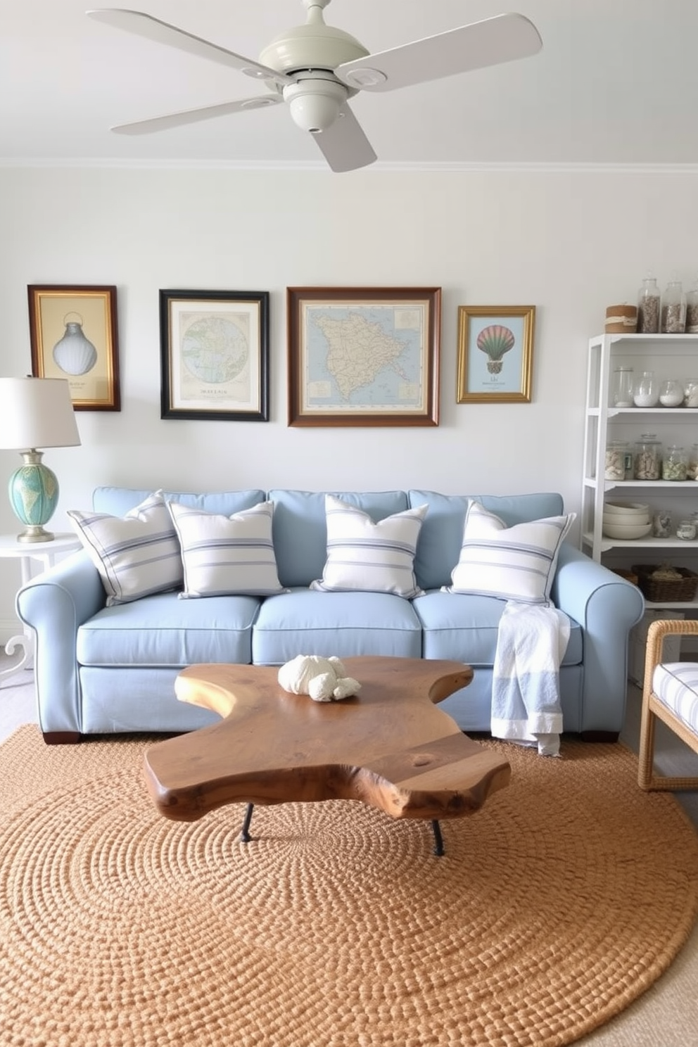 A bright and airy summer apartment decorated with nautical elements. The living room features a light blue sofa adorned with striped throw pillows and a driftwood coffee table at the center. On the walls, framed vintage nautical maps and seashell art add a coastal touch. A woven jute rug anchors the space, while decorative lanterns and a collection of glass jars filled with sand and shells are displayed on the shelves.