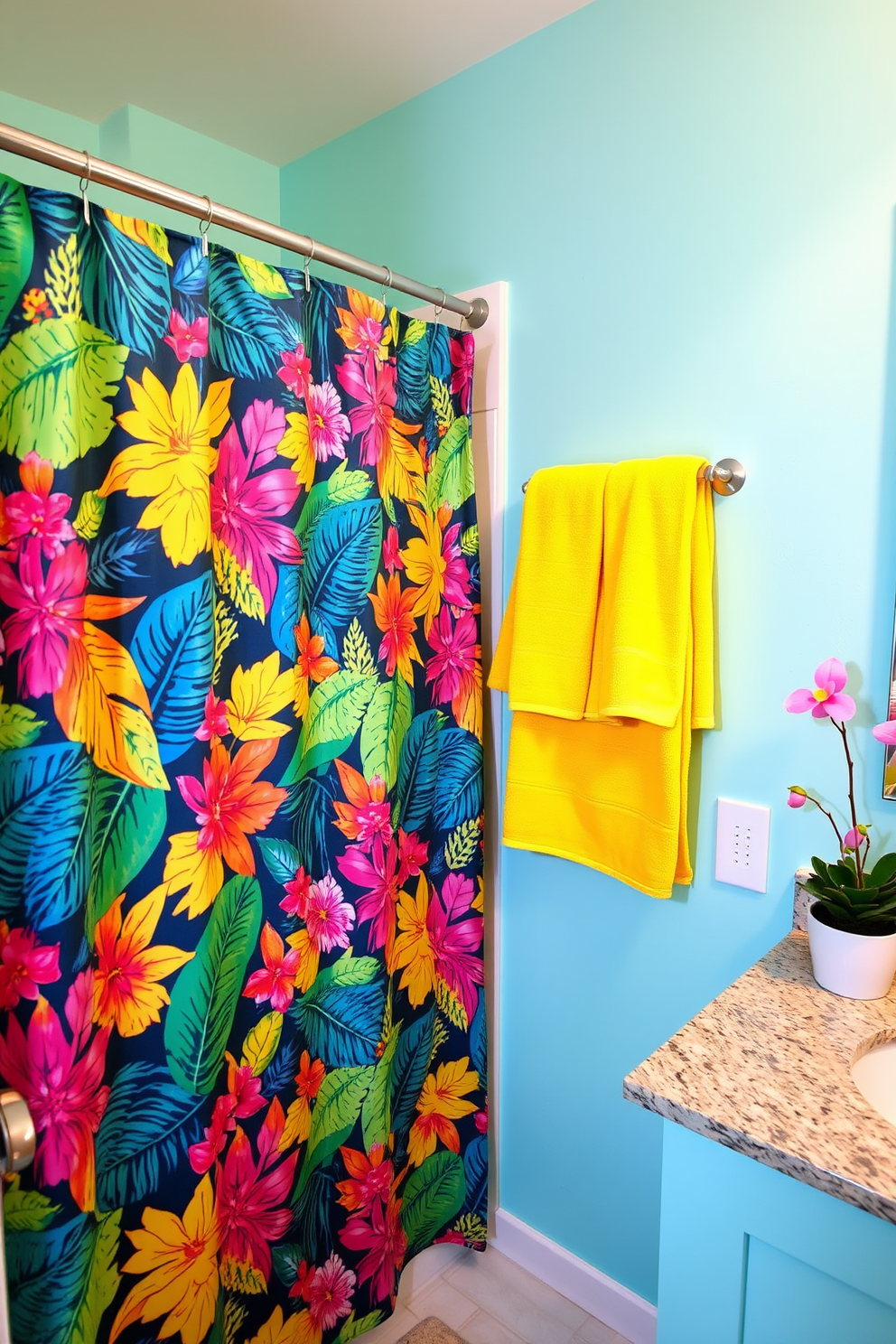 A vibrant bathroom filled with summer vibes. The focal point is a fun patterned shower curtain featuring colorful tropical leaves and flowers. Bright yellow towels are neatly hung on a rack next to the shower. The walls are painted a soft aqua blue, and a small potted plant adds a fresh touch on the countertop.