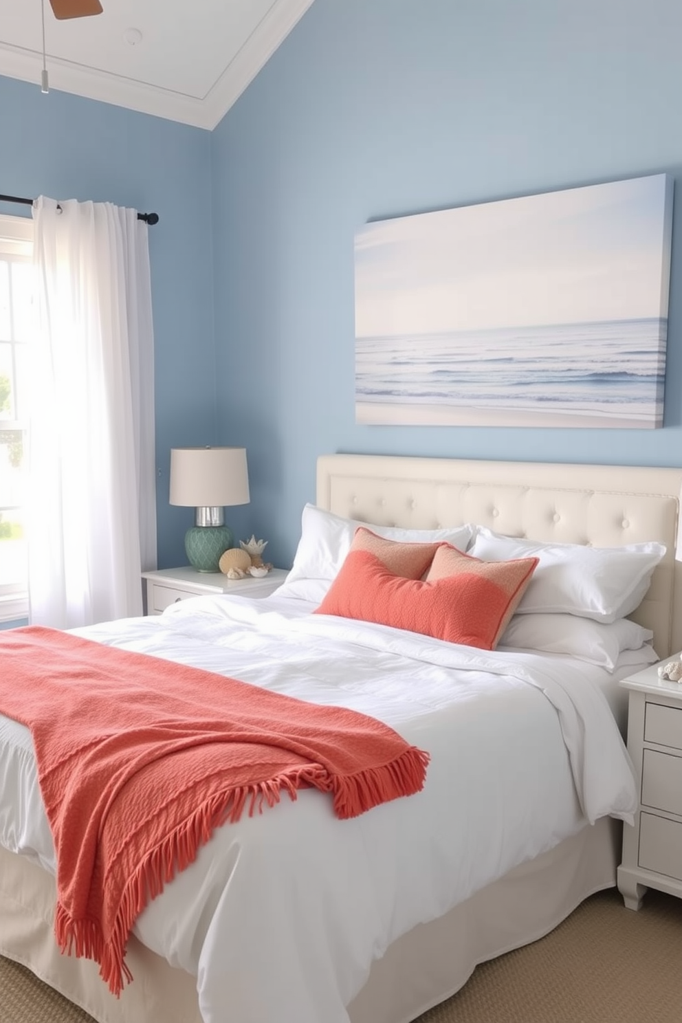 A serene summer bedroom setting. The walls are painted in a soft blue hue, and light, airy curtains flutter gently in the breeze. A large, plush bed is adorned with white linens and a bright coral throw blanket. Beach-themed decor accents include seashells arranged on the nightstand and a large canvas print of a tranquil ocean scene above the bed.