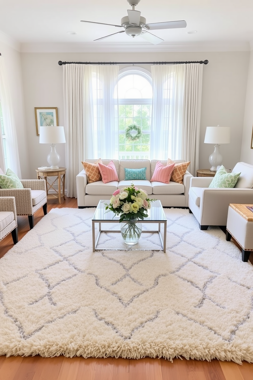 A bright and airy living room showcases a large, plush area rug in soft pastel colors that ties the room together. Surrounding the rug are a comfortable sectional sofa and a pair of accent chairs, creating an inviting space for relaxation. Add a touch of summer with vibrant throw pillows and lightweight, sheer curtains that flutter gently in the breeze. A centerpiece of fresh flowers in a glass vase sits on the coffee table, enhancing the seasonal vibe.