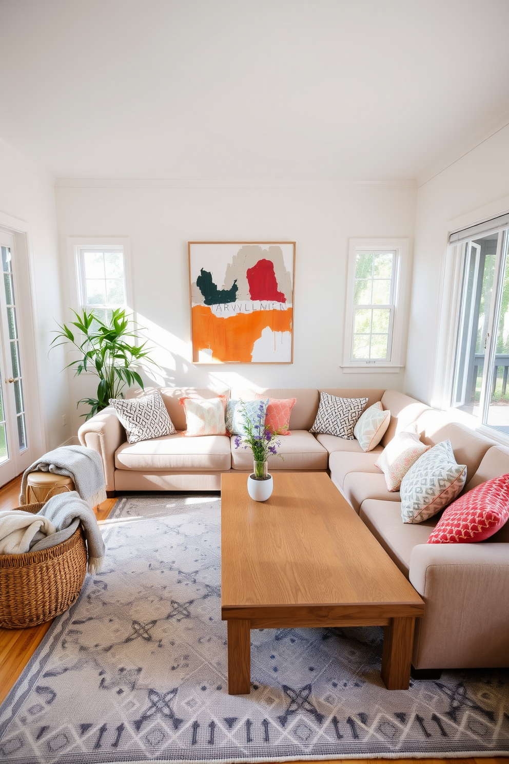 A bright and airy living room filled with natural light. The space features a large wooden coffee table surrounded by a plush sectional sofa adorned with colorful throw pillows. In one corner, a tall potted plant adds a touch of greenery, while a woven basket holds cozy blankets. The walls are painted in a soft pastel hue, and a large piece of abstract art hangs above the sofa, creating a focal point in the room.